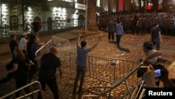 Law enforcement officers stand guard near the parliament building as demonstrators hold a rally to protest against a bill on "foreign agents" in Tbilisi, Georgia, April 30, 2024.