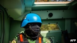 FILE - FILE - An United Nations peacekeeper holds his weapon during the the patrol in Paoua, Central African Republic on December 5, 2021.