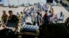 British nationals prepare to board a Royal Air Force aircraft at Wadi Seidna Air Base, Sudan, April 27, 2023. The U.N. relocated hundreds of staff from Khartoum and the western Darfur region to Port Sudan in the east this week. (UK Ministry of Defence via AP)