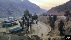 Stranded trucks loaded with supplies for Afghanistan park in a terminal alongside on a highway, Feb. 21, 2023, after Afghan Taliban rulers closed a key border crossing point Torkham, in Pakistan's district Khyber along the Afghan border.