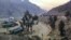 Stranded trucks loaded with supplies for Afghanistan park in a terminal alongside on a highway, Feb. 21, 2023, after Afghan Taliban rulers closed a key border crossing point Torkham, in Pakistan's district Khyber along the Afghan border.