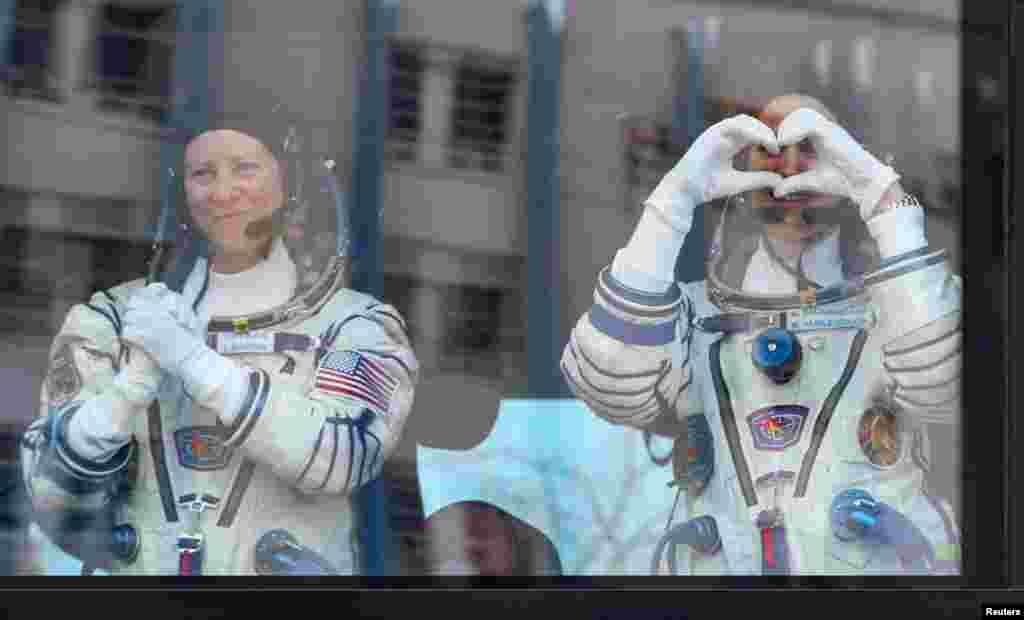 NASA astronaut Tracy Dyson and Spaceflight participant Marina Vasilevskaya of Belarus react during their space suit check shortly before launch to the International Space Station (ISS) at the Baikonur Cosmodrome, Kazakhstan.