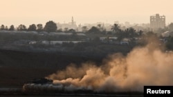 A tank maneuvers near the Israel-Gaza border, amid the ongoing conflict between Israel and Hamas, in Israel, Aug. 7, 2024. 