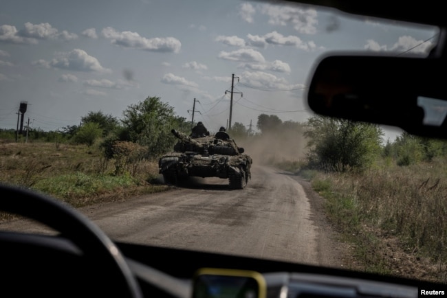 Ukrainian servicemen ride on a tank, as Russia's attacks on Ukraine continue, near the village of Robotyne, Zaporizhzhia region, Ukraine, Aug. 25, 2023.