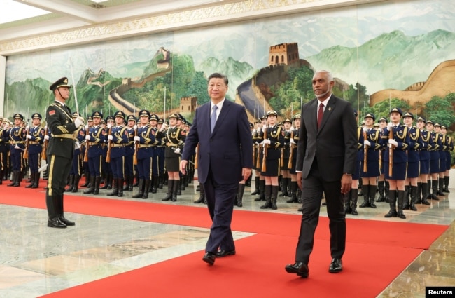 FILE - Chinese President Xi Jinping and Maldivian President Mohamed Muizzu attend a welcome ceremony at the Great Hall of the People in Beijing, China, Jan. 10, 2024. The Maldives government has been taking steps to move closer to India's rival, China. (CNSPhoto via Reuters)
