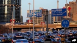 Motorists are stuck in a traffic jam during rush hour along the main business district in Beijing, China, March 22, 2024.