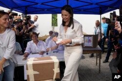 Opposition presidential hopeful Maria Corina Machado casts her ballot during the opposition primary election in Caracas, Venezuela, Oct. 22, 2023.