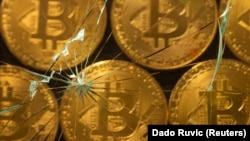 (FILE) Virtual currency bitcoin are seen through broken glass.