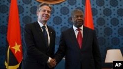 U.S. Secretary of State Antony Blinken, left, and Angolan President Joao Lourenco shake hands during their meeting at the Presidential Palace in Luanda, Angola, Jan. 25, 2024.