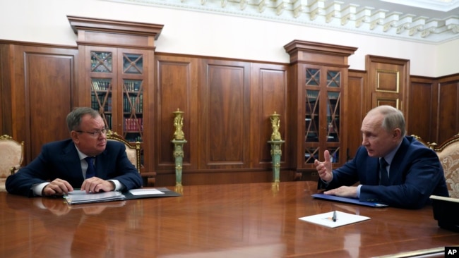 Russian President Vladimir Putin, right, speaks to VTB Bank Chairman Andrei Kostin during their meeting in Moscow, Nov. 27, 2023. (Mikhail Klimentyev, Sputnik, Kremlin Pool Photo via AP)