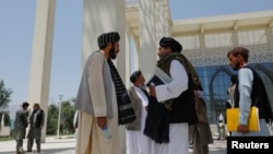 FILE - Taliban members are seen at Kabul University in Kabul, Afghanistan, June 14, 2023.