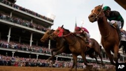 Brian Hernandez Jr. and Mystik Dan, right, get to the finish line first to win the 150th running of the Kentucky Derby horse race at Churchill Downs in Louisville, Kentucky, May 4, 2024.