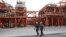 FILE - Two Iranian technicians walk at a natural gas refinery at the South Pars gas field on the northern coast of the Persian Gulf, in Asaluyeh, Iran, March 16, 2019.