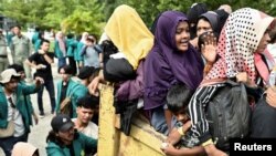 Rohingya Muslim refugees are transported as they are relocated from their temporary shelter at Balai Meuseuraya Aceh, following a protest for the deportation of the Rohingya refugees in Banda Aceh, Dec. 27, 2023.