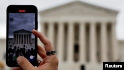 FILE - A person shoots with a mobile at the U.S. Supreme Court building in Washington, Oct. 31, 2022.