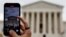 FILE - A person shoots with a mobile at the U.S. Supreme Court building in Washington, Oct. 31, 2022.
