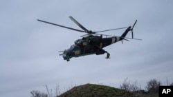 A Ukrainian Mi-24 attack helicopter flies towards Russian positions during a combat mission in Donetsk region, Ukraine, March 18, 2023.