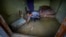 Ganga Ram Subba, searches for his documents in the mud inside his house in the flood affected area along the Teesta river in Rongpo, east Sikkim, India, Oct. 8. 2023. 