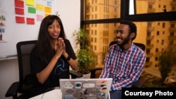 Ethiopian digital app inventor Eden Tadesse is pictured with software engineer Mohammad Jamalaldeen, a South Sudanese refugee, as she helps him get acquainted with career development services in a co-working space in Addis Ababa, Ethiopia, Aug. 6, 2023. (Photo by Johann Vorster)