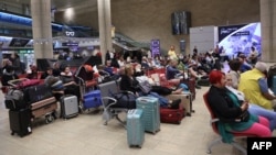 Passengers wait at Ben Gurion Airport near Tel Aviv, Israel, Oct. 7, 2023, as flights are canceled because of the Hamas surprise attack.