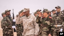 FILE - Gen. Michael Langley, USMC, Commander, U.S. Africa Command, center, and Major Gen. Mohammed Berrid, Inspector General of Moroccan Royal Armed Forces, attend the African Lion military exercise, in Tantan, Morocco, May 31, 2024.