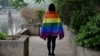 FILE - A gay student sports a rainbow flag in Beijing, May 10, 2019. The Beijing LGBT Center, one of China's leading organizations providing resources and support for the queer population, announced in May 2023 that it would cease operations.