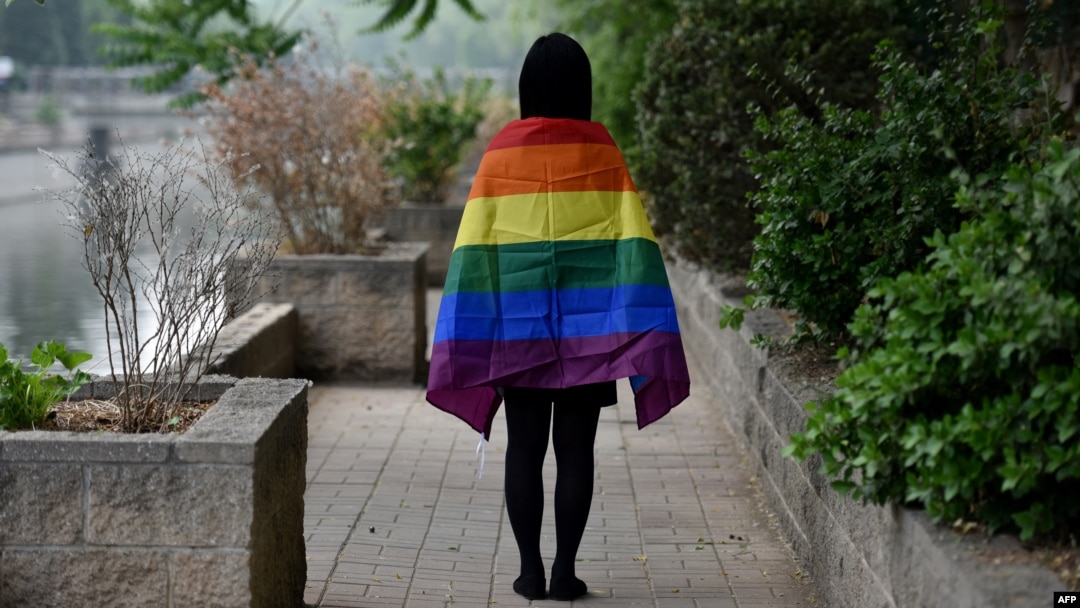 FILE - A gay student sports a rainbow flag in Beijing, May 10, 2019. The Beijing LGBT Center, one of China's leading organizations providing resources and support for the queer population, announced in May 2023 that it would cease operations.