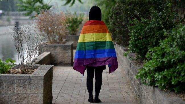 FILE - A gay student sports a rainbow flag in Beijing, May 10, 2019. The Beijing LGBT Center, one of China's leading organizations providing resources and support for the queer population, announced in May 2023 that it would cease operations.