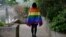 FILE - A gay student sports a rainbow flag in Beijing, May 10, 2019. The Beijing LGBT Center, one of China's leading organizations providing resources and support for the queer population, announced in May 2023 that it would cease operations.