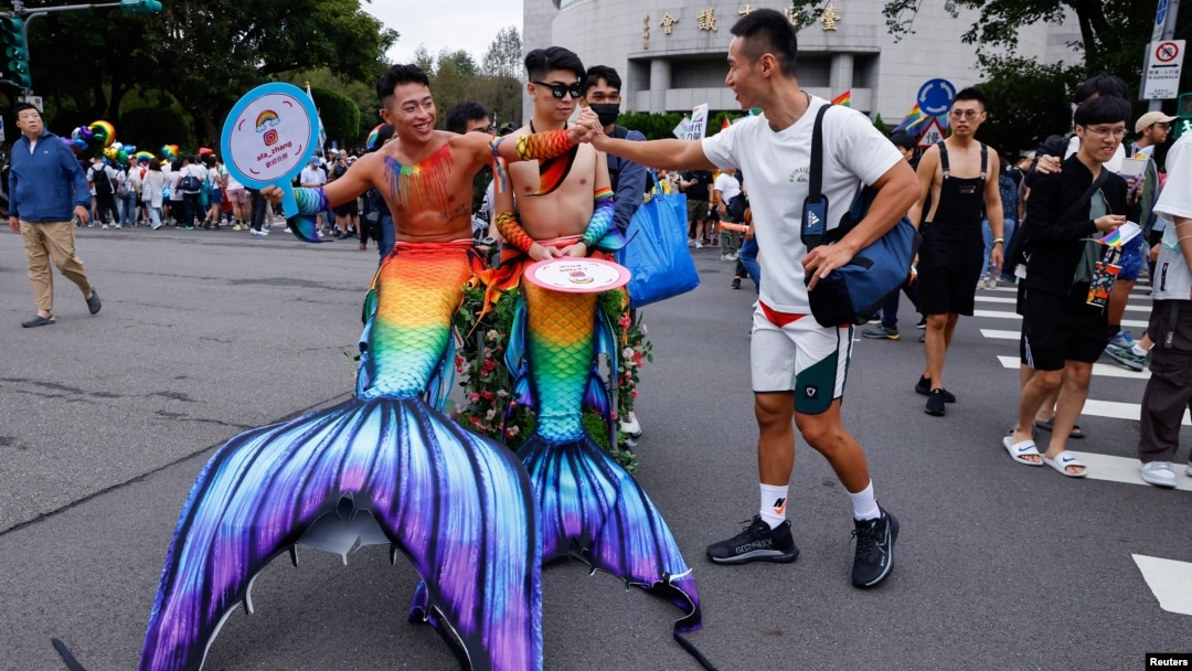 Friends greet each other at the annual Taiwan's Pride parade in Taipei, Taiwan, Oct. 28, 2023.