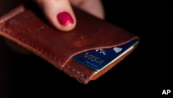 A Visa card is displayed in a wallet in Portland, Oregon, May 15, 2024. The same day, Visa announced major changes to how credit and debit cards will operate in the U.S. in the coming months and years. 