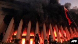 Firefighters douse a fire at the Post Office building in Manila, Philippines. 