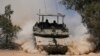 Israeli soldiers drive a tank near the Israeli-Gaza border, in southern Israel, May 29, 2024.