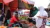 FILE - Somalis buy vegetables at a market in Mogadishu, June 12, 2022.