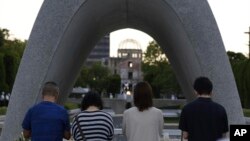 Visitors pray in front of the cenotaph dedicated to the victims of the atomic bombing at the Hiroshima Peace Memorial Park in Hiroshima, western Japan, Aug. 6, 2023.
