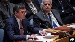 Ukraine Foreign Minister Dmytro Kuleba, left, addresses the U.N. Security Council, Feb. 24, 2023, at U.N. headquarters. 