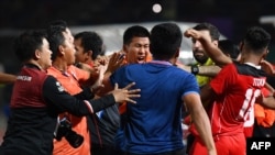 Players and officials react as a fight breaks out on the sidelines of the men's football final match between Thailand and Indonesia during the 32nd Southeast Asian Games (SEA Games) in Phnom Penh on May 16, 2023.