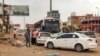 People prepare to board a bus departing from Khartoum in the Sudanese capital's south on April 24, 2023, as battles rage in the city between the army and paramilitaries.