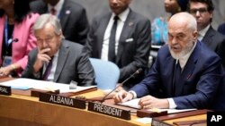 U.N. Secretary-General Antonio Guterres, left, listens as Security Council President and Prime Minister of Albania Edi Rama speaks during a Security Council meeting, Sept. 20, 2023, at U.N. headquarters.