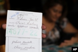 Transgender man Fabricio Chicas holds his Women’s National Hospital user card, filled out with his given name, Patricia Yamileth Chicas Martinez, during an interview in his home in San Salvador, El Salvador, April 30, 2023.