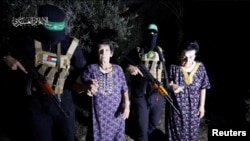 Yocheved Lifshitz and Nurit Cooper, who were held hostage by Palestinian Hamas militants, are released by the militants, in this video screengrab obtained by Reuters on Oct. 23, 2023. (Al-Qassam Brigades, military wing of Hamas)
