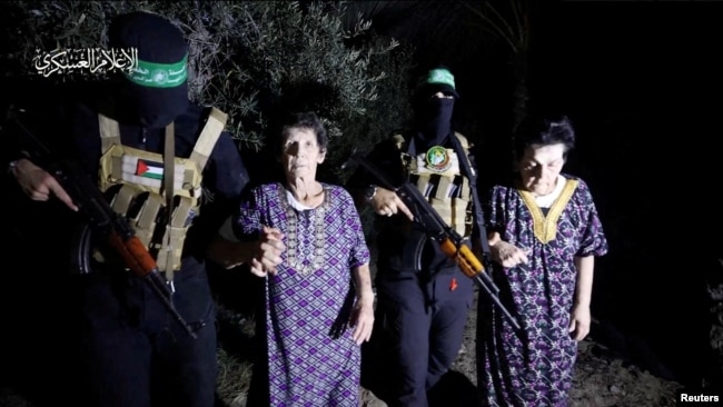 Yocheved Lifshitz and Nurit Cooper, who were held hostage by Palestinian Hamas militants, are released by the militants, in this video screengrab obtained by Reuters on Oct. 23, 2023. (Al-Qassam Brigades, military wing of Hamas)