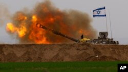 An Israeli mobile artillery unit fires a shell from southern Israel towards the Gaza Strip, in a position near the Israel-Gaza border, Dec. 21, 2023. 