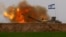 An Israeli mobile artillery unit fires a shell from southern Israel towards the Gaza Strip, in a position near the Israel-Gaza border, Dec. 21, 2023. 