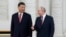 FILE - Russian President Vladimir Putin, right, speaks to Chinese President Xi Jinping in Moscow, Russia, March 21, 2023. On Wednesday, the Kremlin said a visit by Putin to China was on the agenda (Sergei Karpukhin, Sputnik, Kremlin Pool Photo via AP, File)
