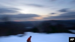 FILE - A skier descends Black Mountain of Maine, Feb. 11, 2023, in Rumford, Maine.