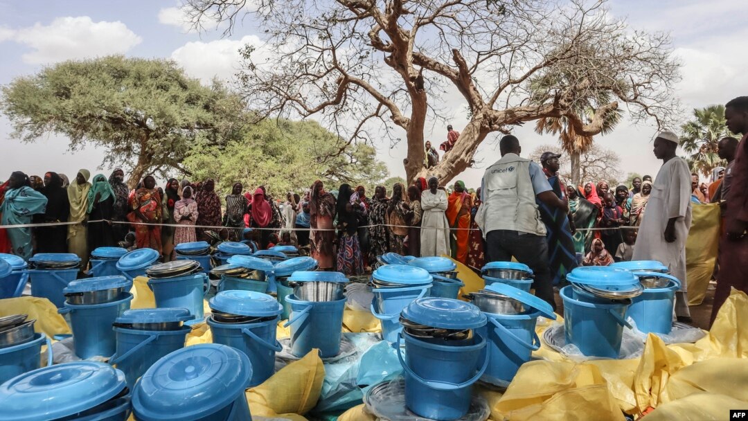Personnel form the United Nations Children's Fund (UNICEF) and from the NGO Premiere Urgence prepare aid kits for Sudanese refugees who crossed into Chad, in Koufroun, near Echbara, on April 30, 2023.