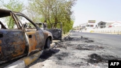 Burnt cars are pictured at the site of a sit-in near the headquarters of the Iraqi security forces in the multi-ethnic Iraqi city of Kirkuk, Sept. 3, 2023, after curfew was lifted. 