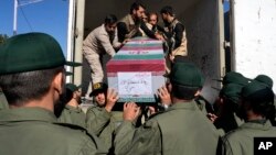 Iranian soldiers move a flag-draped coffin of a victim of a Jan. 3 bomb explosion in Kerman, about 820 kms southeast of Tehran, Iran, Jan. 5, 2024. Iran's state TV reported on Jan. 21 that a soldier killed five comrades in Kerman.