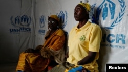 Marie Dzedza, who fled her home five years ago and whose hands were amputated by members from the CODECO armed group with a machete, sits at the Kigonze IDP camp in Bunia, Ituri province of the Democratic Republic of Congo March 2, 2023.